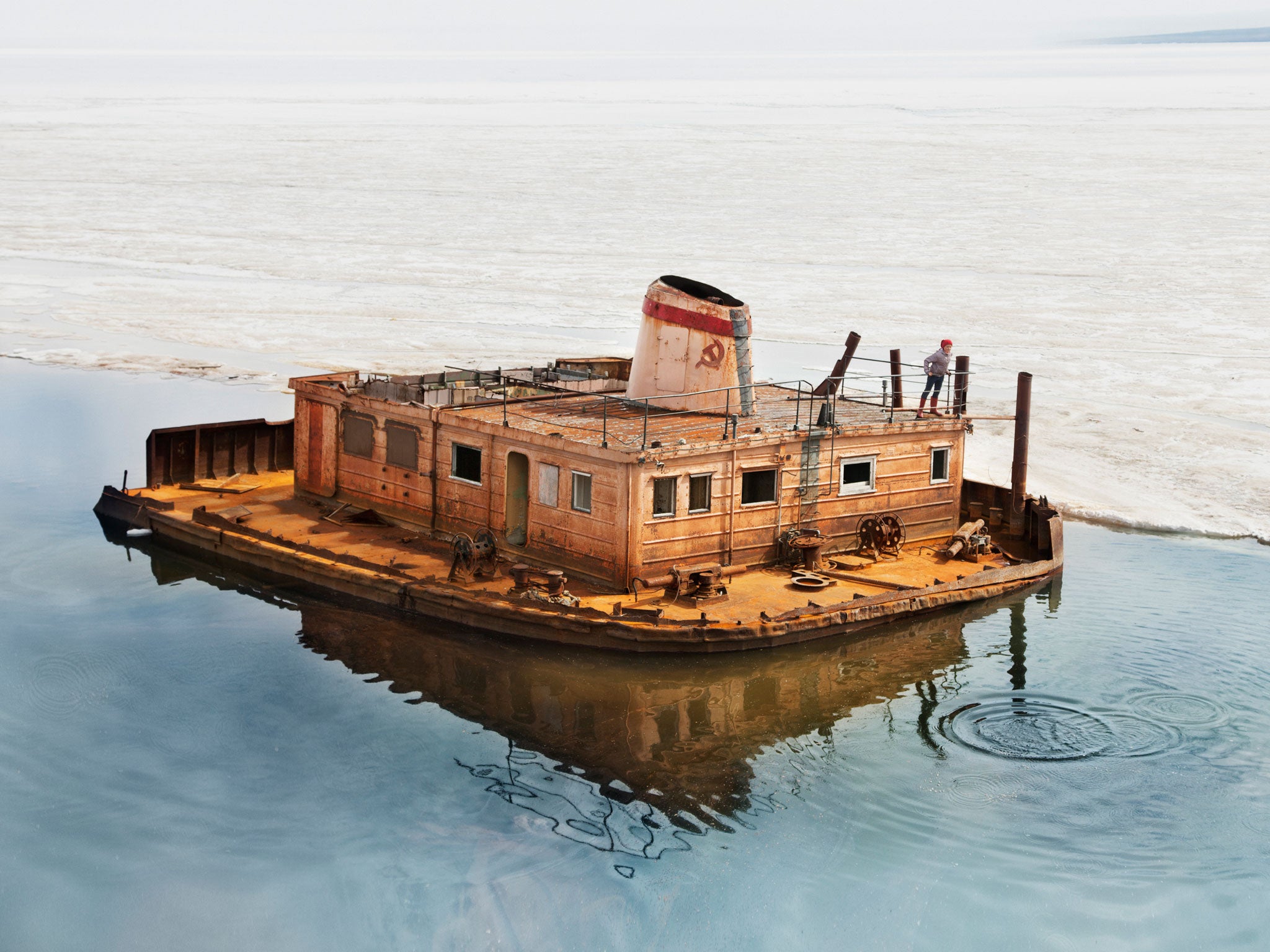 Tanya explores a rusting barge near Tiksi’s seaport