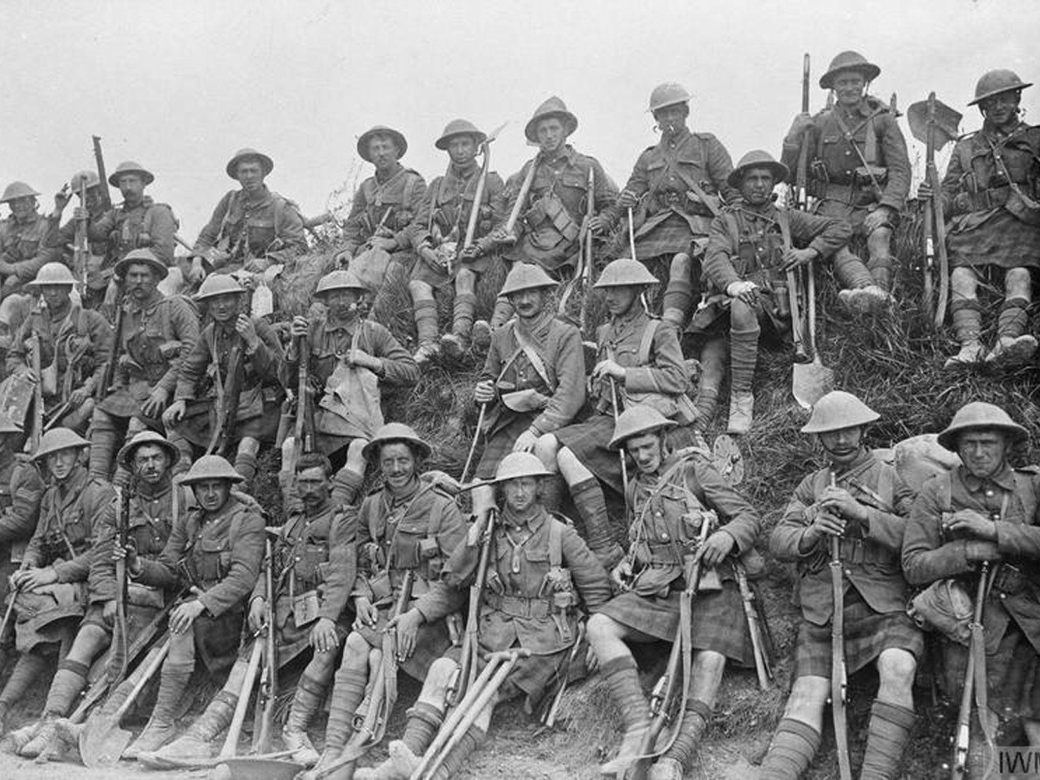 Gordon Highlanders rest at the roadside, July 1916. They carry the tools of their trade - the Short Magazine Lee-Enfield bolt action rifle, and the spade