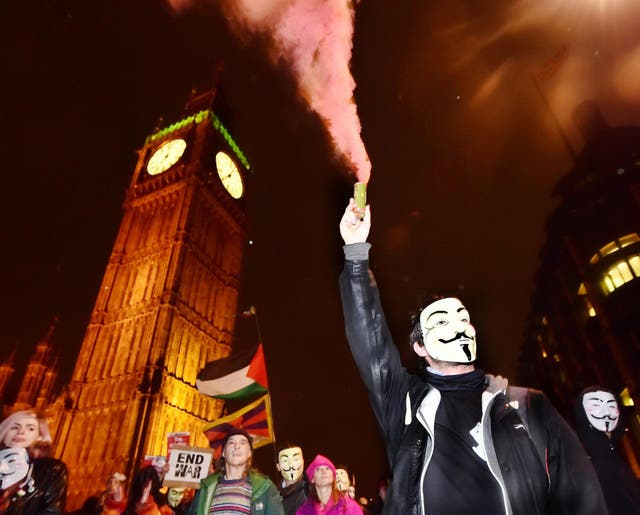 A protester lights a flare near Big Ben