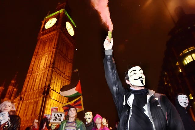 A protester lights a flare near Big Ben