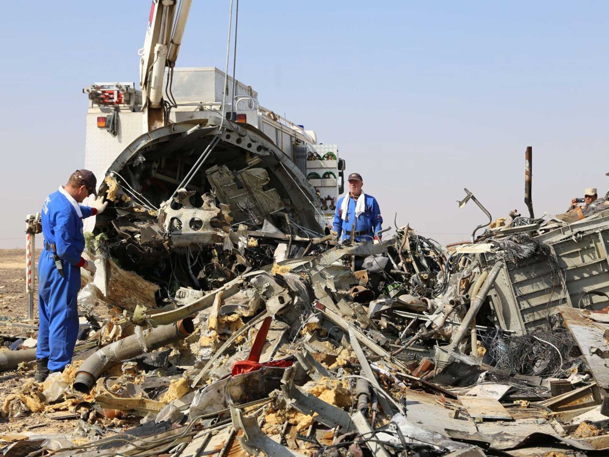 Russian investigators comb through the wreckage in the Sinai Peninsula