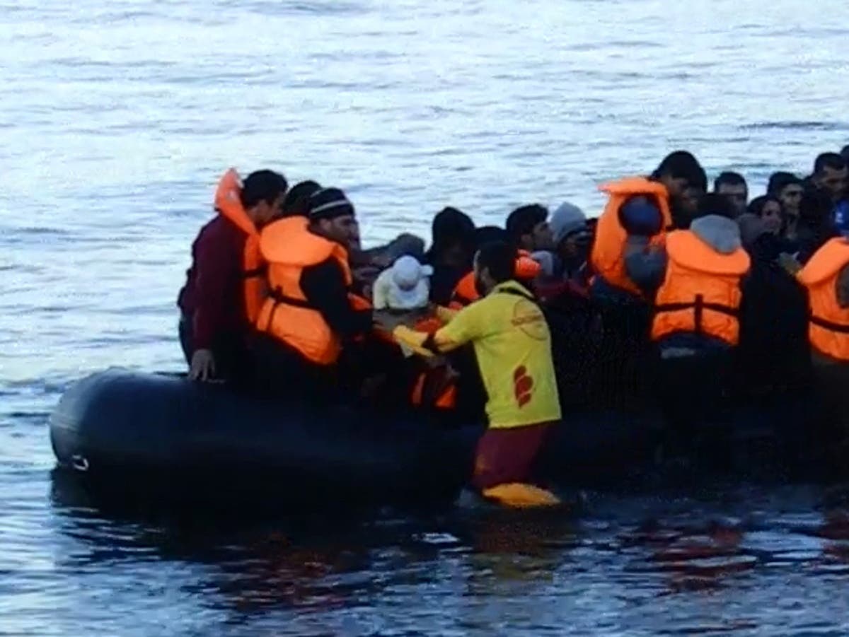Video shows babies being brought ashore in refugee boat after at least