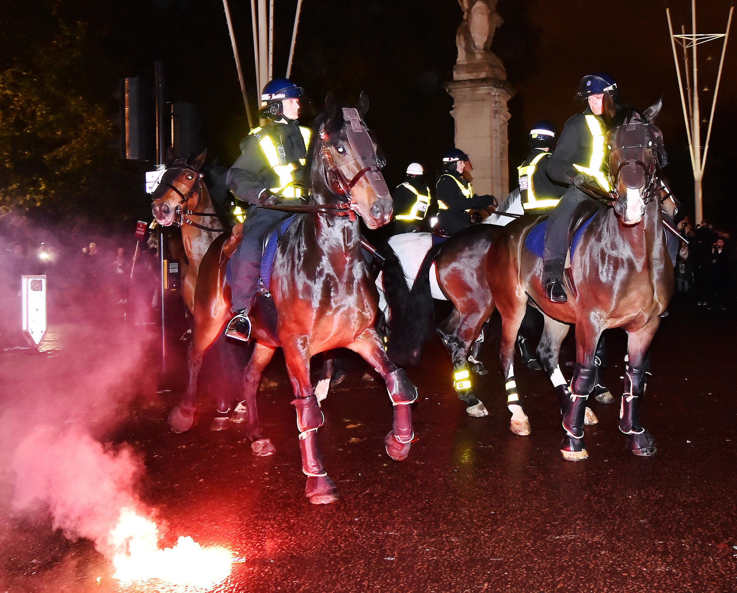 Protesters let off flares near police horses outside St James Park. One police horse is said to have bolted when an explosive flew past its head.