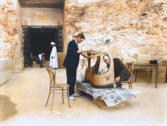 Arthur Mace and Alfred Lucas work on a golden chariot from Tutankhamun's tomb outside the "laboratory" in the tomb of Sethos II, December 1923. Image courtesy of Griffith Institute, University of Oxford, colourised by Dynamichrome