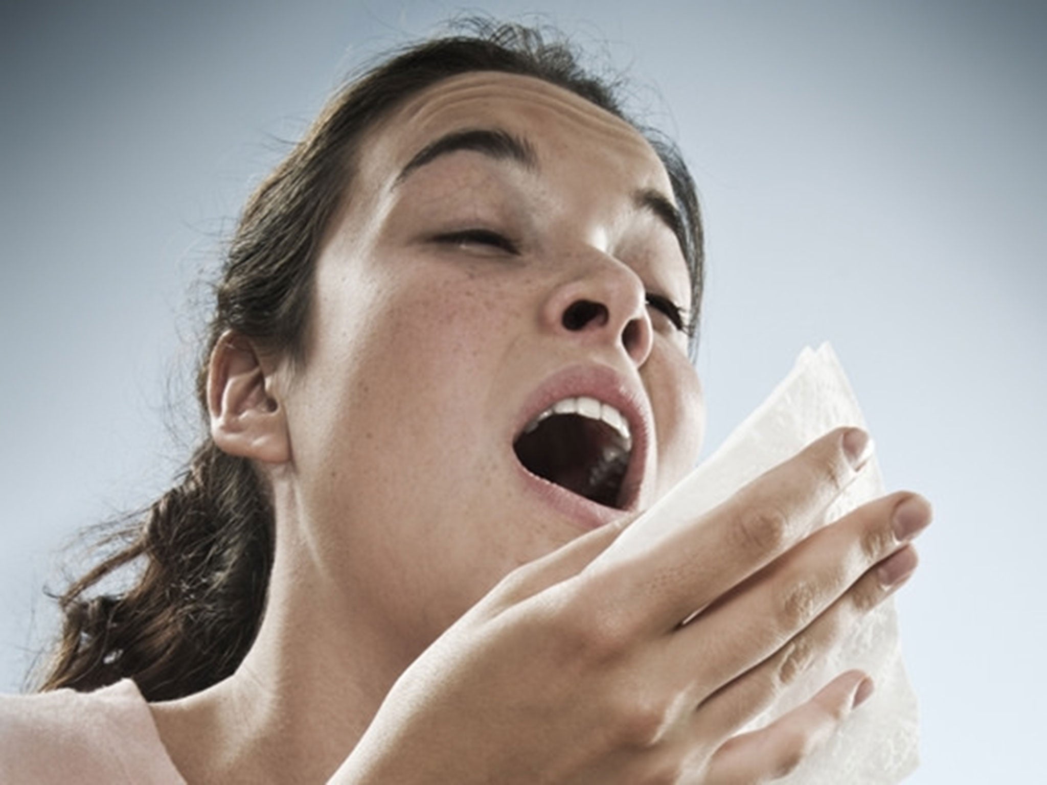 A woman sneezes
