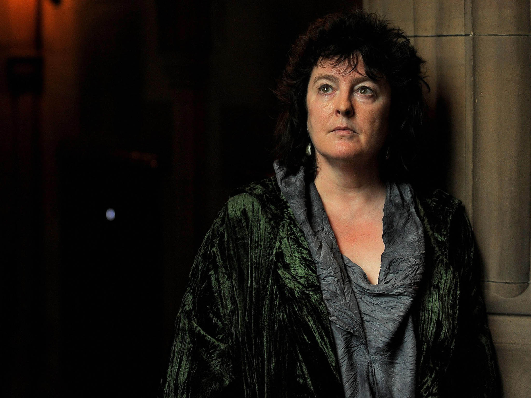 The Poet Laureate Carol Ann Duffy poses for photographers in the John Rylands Library