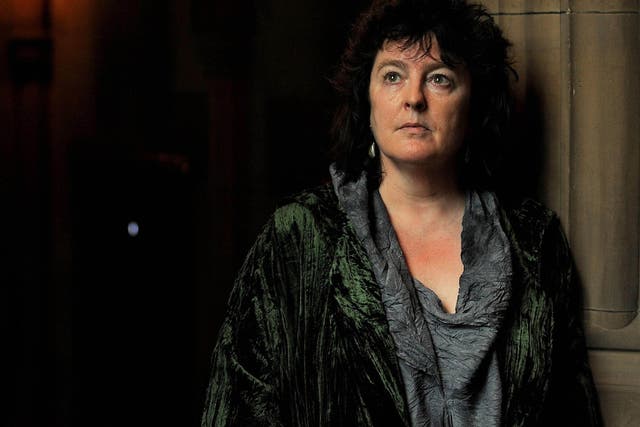 The Poet Laureate Carol Ann Duffy poses for photographers in the John Rylands Library