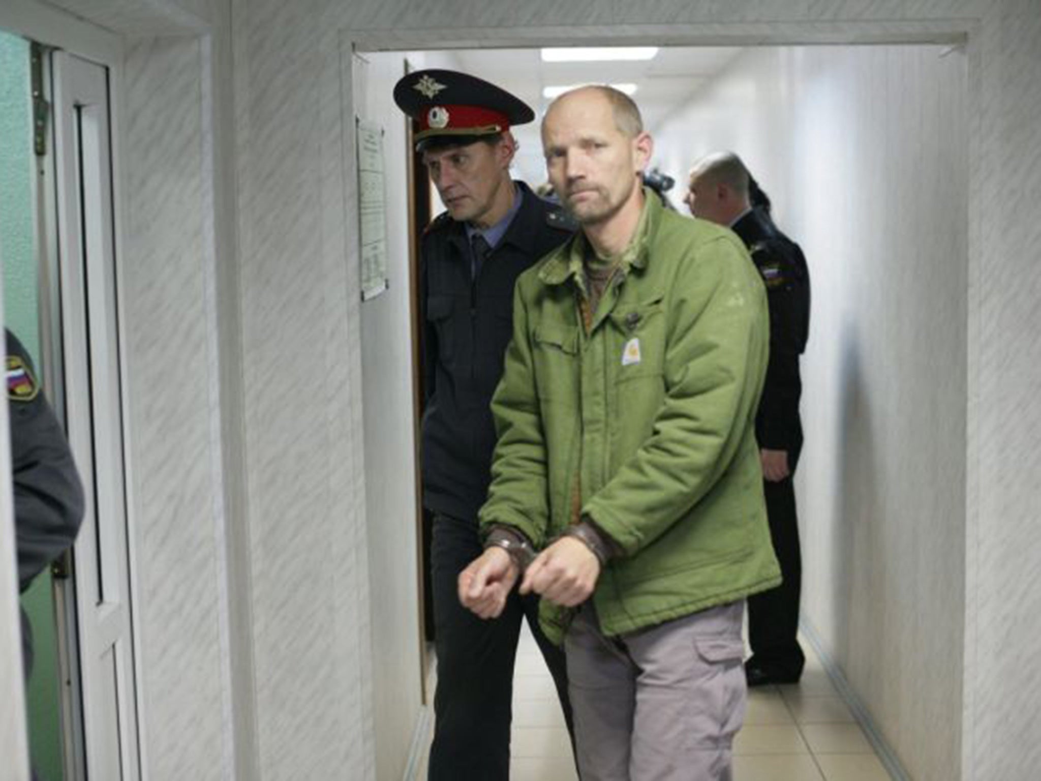 Frank Hewetson is led into the Leninsky District Court Of Murmansk, Russia, 26 September 2013