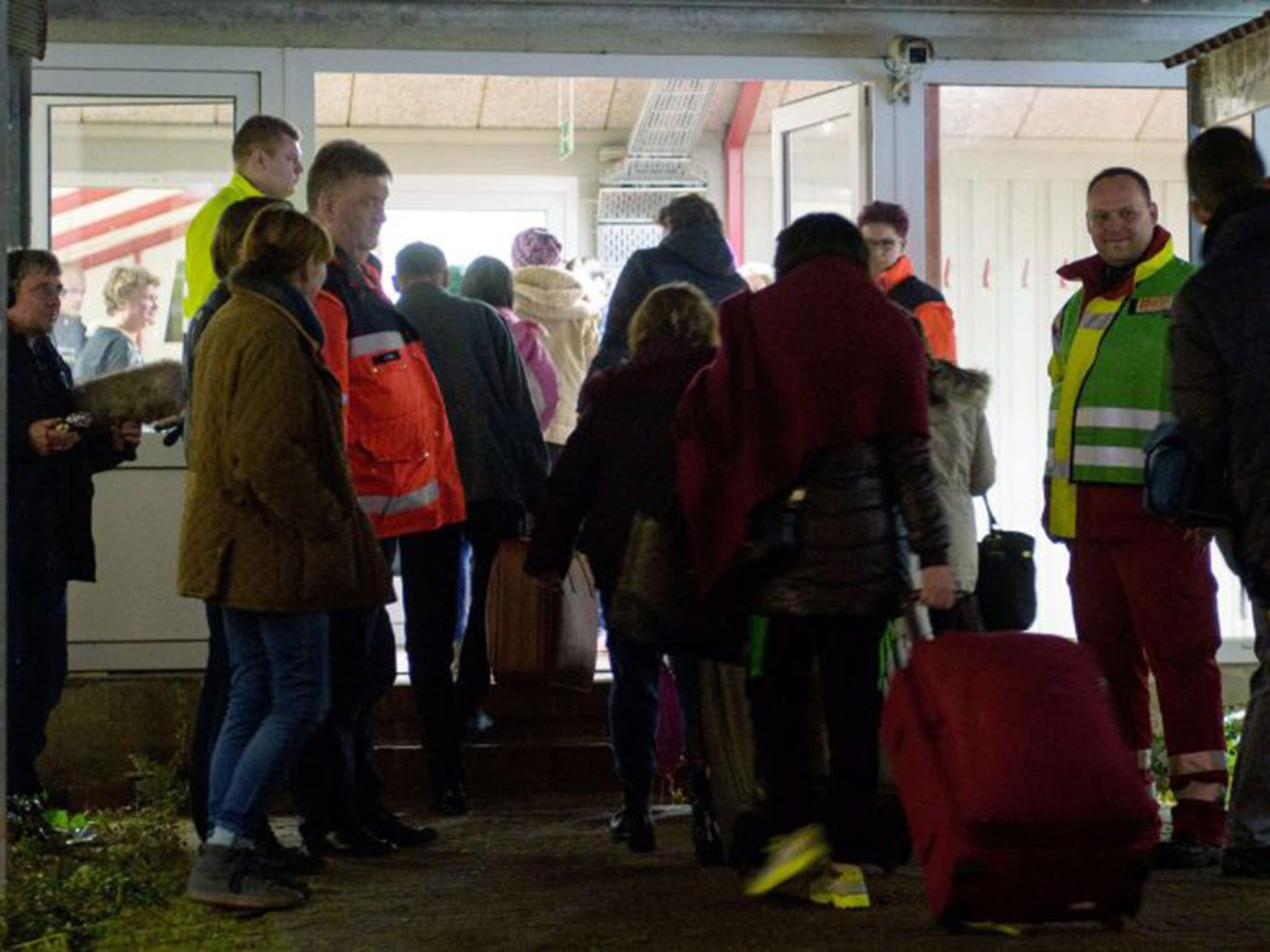 Refugees arrive at the emergency accomodation in Sumte