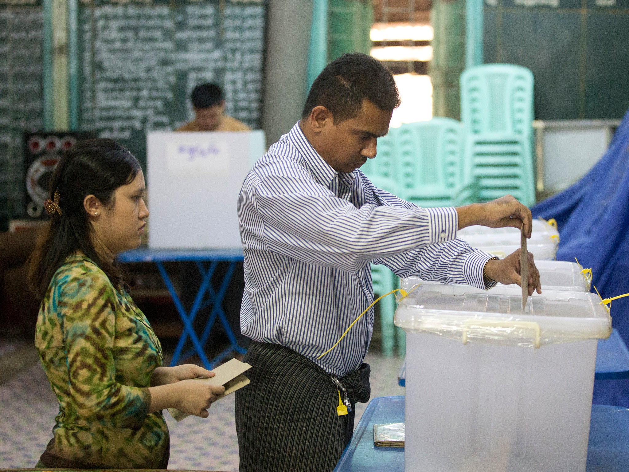 A couple cast their vote at a polling booth for advance voting in central in Rangoon