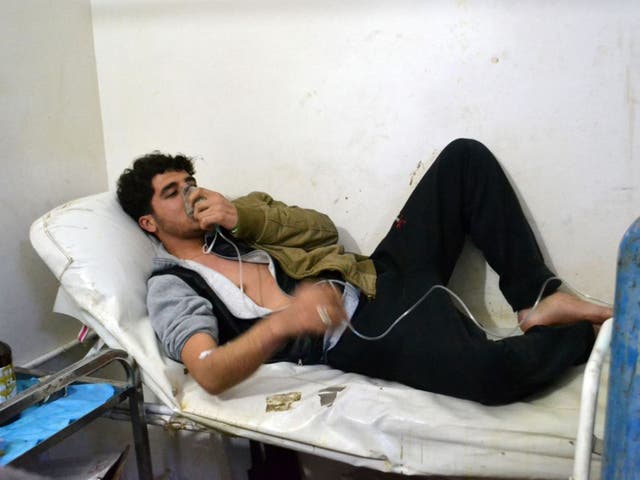 A man breathes with aid of an oxygen mask following a mustard gas attack in Idlib, Syria, earlier this year