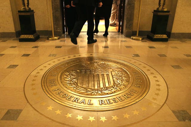 People walk into a meeting of the Board of Governors at the Federal Reserve