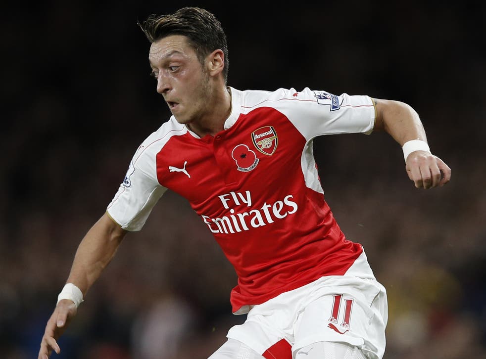 Arsenal playmaker Mesut Ozil in action against Tottenham