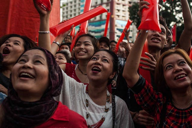 Supporters cheer as they wait for results at a National League for Democracy rally in Rangoon