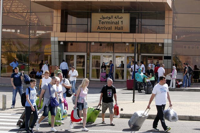 Tourists walk outside Sharm el-Sheikh airport