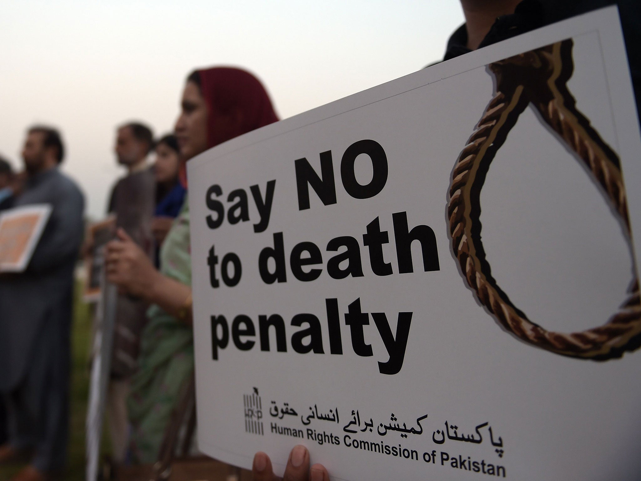 Activists from the Human Rights Commission of Pakistan (HRCP) carry placards during a demonstration in Islamabad on October 10, 2015