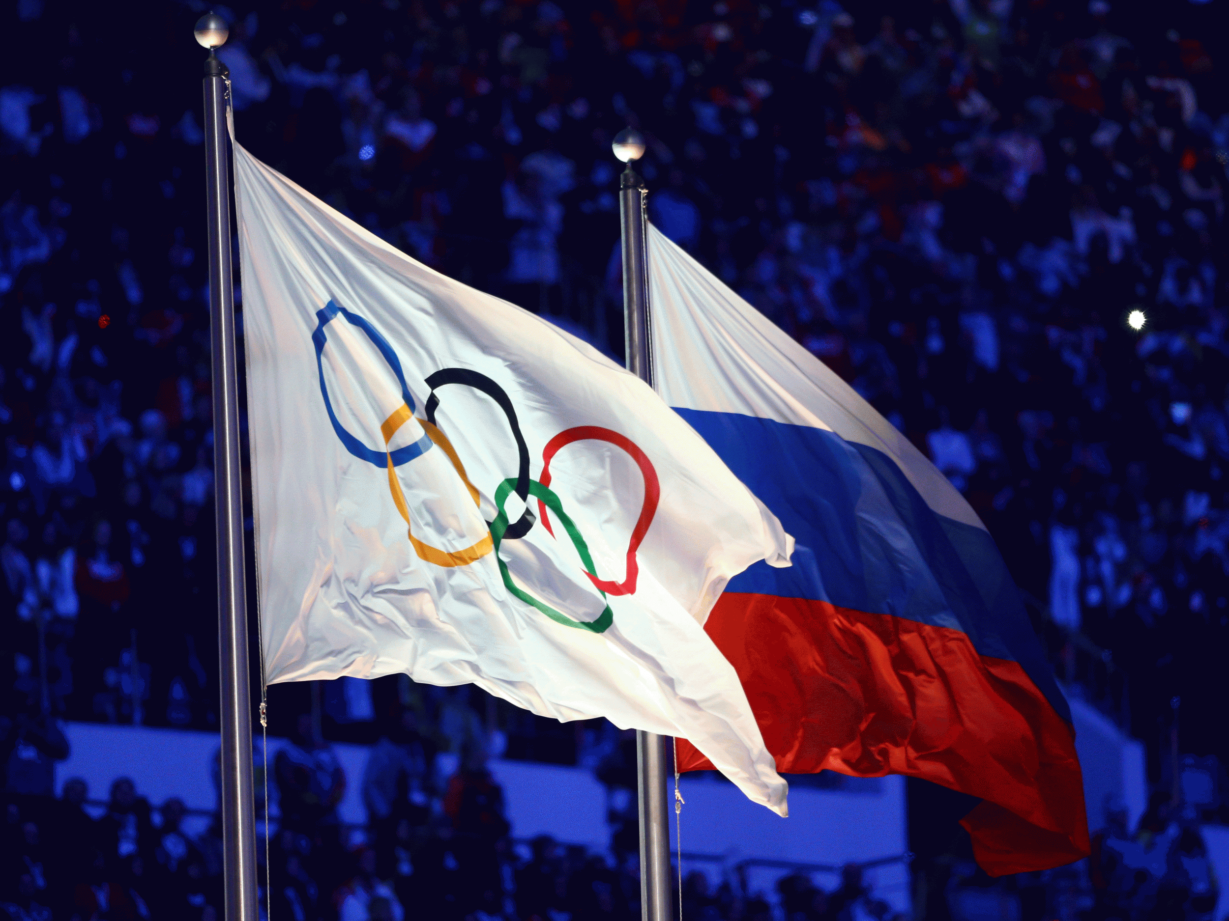 The Olympic and Russian flags fly side-by-side at the 2014 Sochi Winter Olympic Games