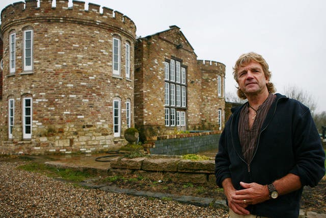 Robert Fidler outside the mock Tudor castle home that he built without planning permission in 2000 at Honeycrock Farm, Salfords, Surrey
