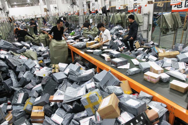 Express crew deal with express packages at assembly line on November 12, 2014 in Wenzhou, Zhejiang province of China. Online shopping websites offered massive discounts on Singles' Day (November 11) every year, which brings huge pressure to China's express delivery business during that day.