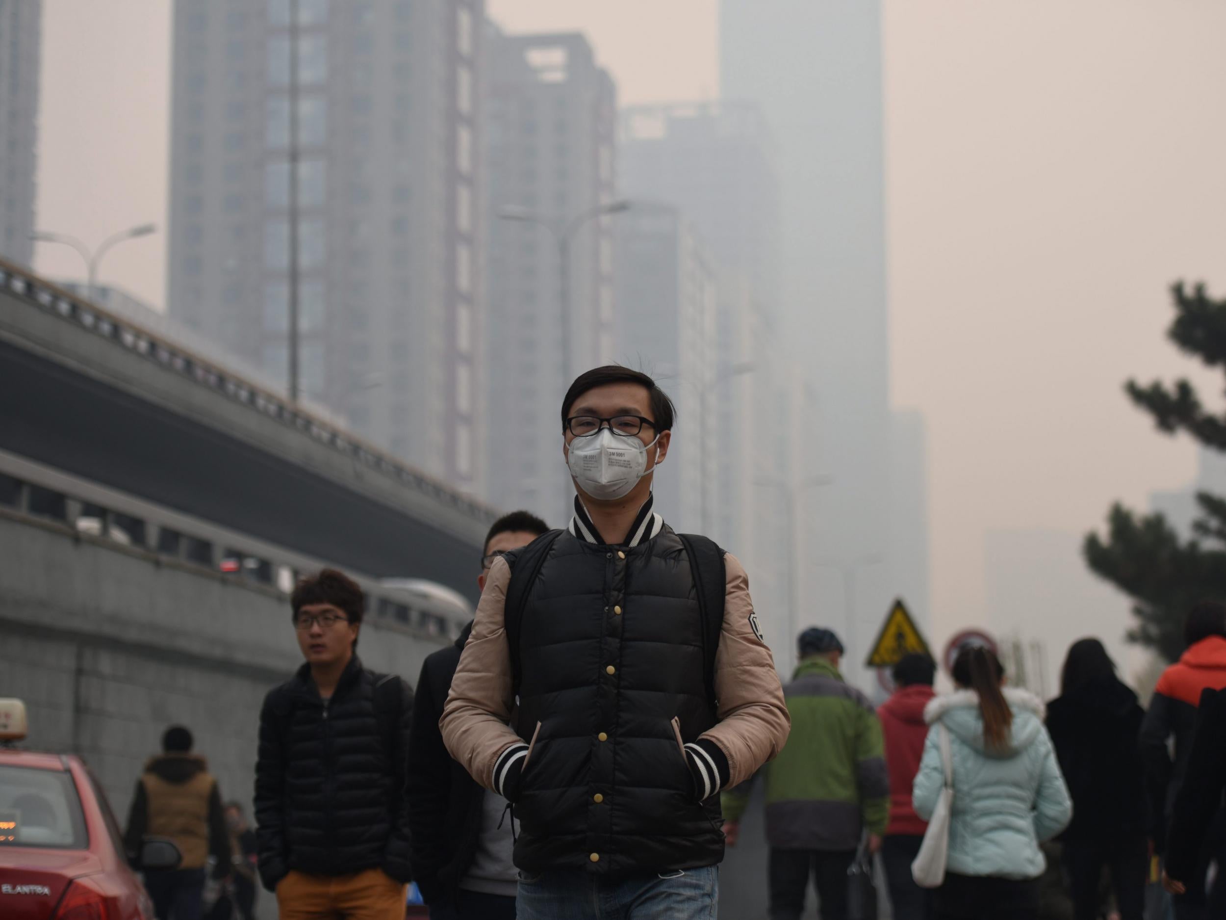 A citizen walks amid the heavy haze in Shenyang in northeast China's Liaoning province