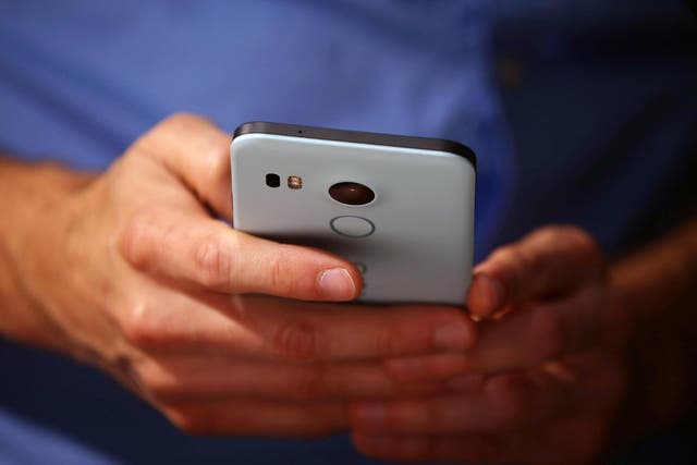 A man inspects the Nexus 5X at an unveiling event in September 2015