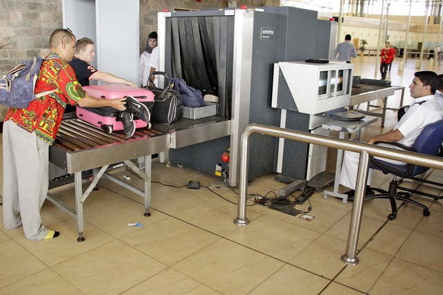 Security officials screen luggage at Sharm el-Sheikh Airport