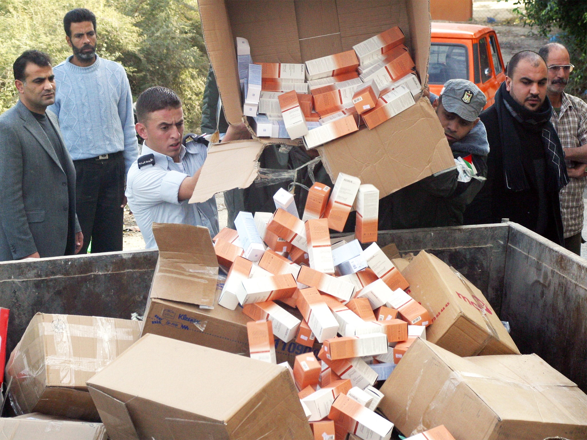 Palestinian customs officials dump Ahava products seized from West Bank shops during a 2009 boycott