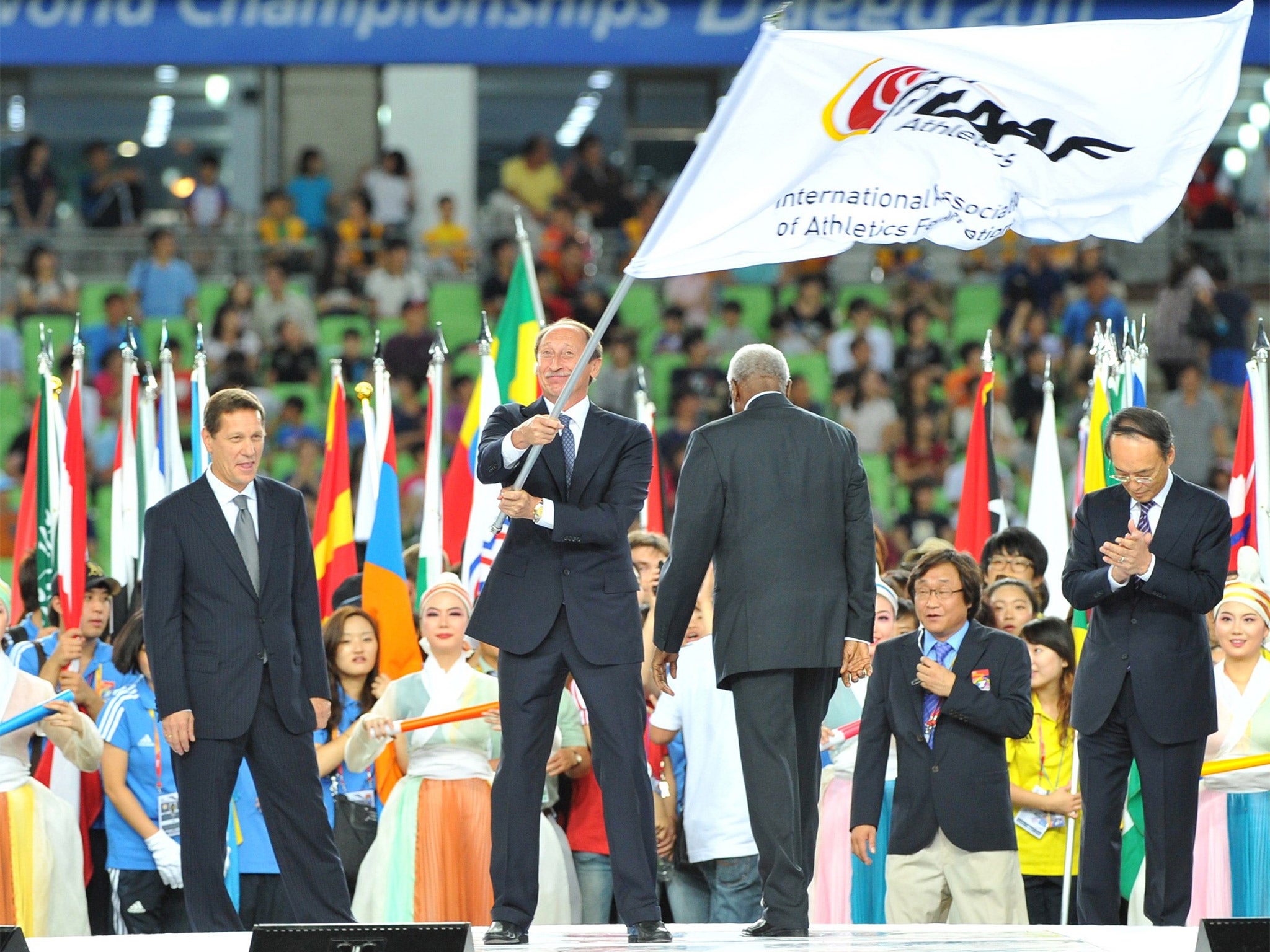 Valentin Balakhnichev, former head of the Russian Athletics Federation, waves the IAAF flag at the 2011 World Championships in Daegu
