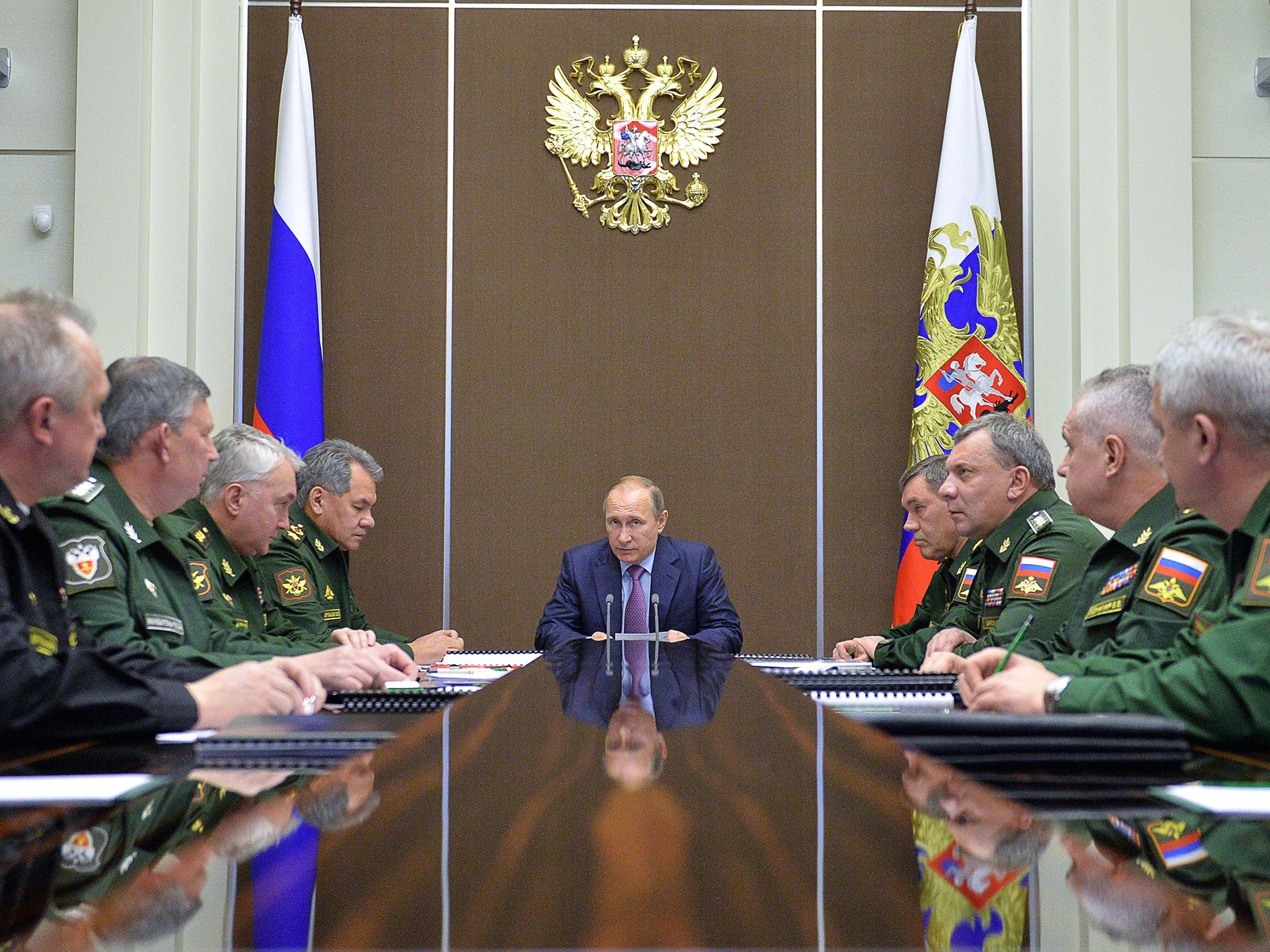 Russian President Vladimir Putin chairs a meeting with defense officials in the Bocharov Ruchei residence in the Black Sea resort of Sochi, Russia, Tuesday, Nov. 10, 2015