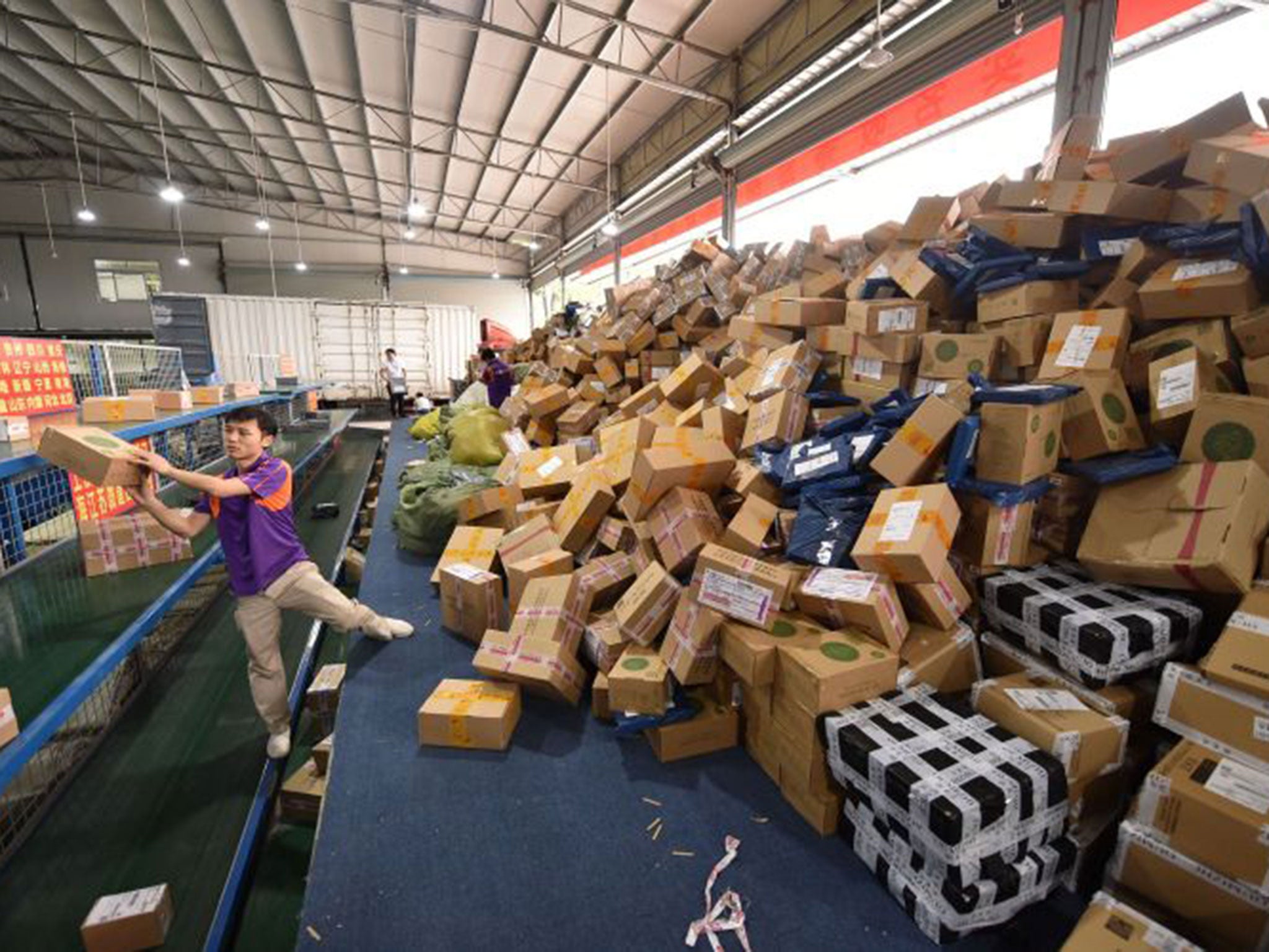 Workers sort out packages at a sorting center in Guangzhou, capital of south China's Guangdong Province, Nov. 11, 2015