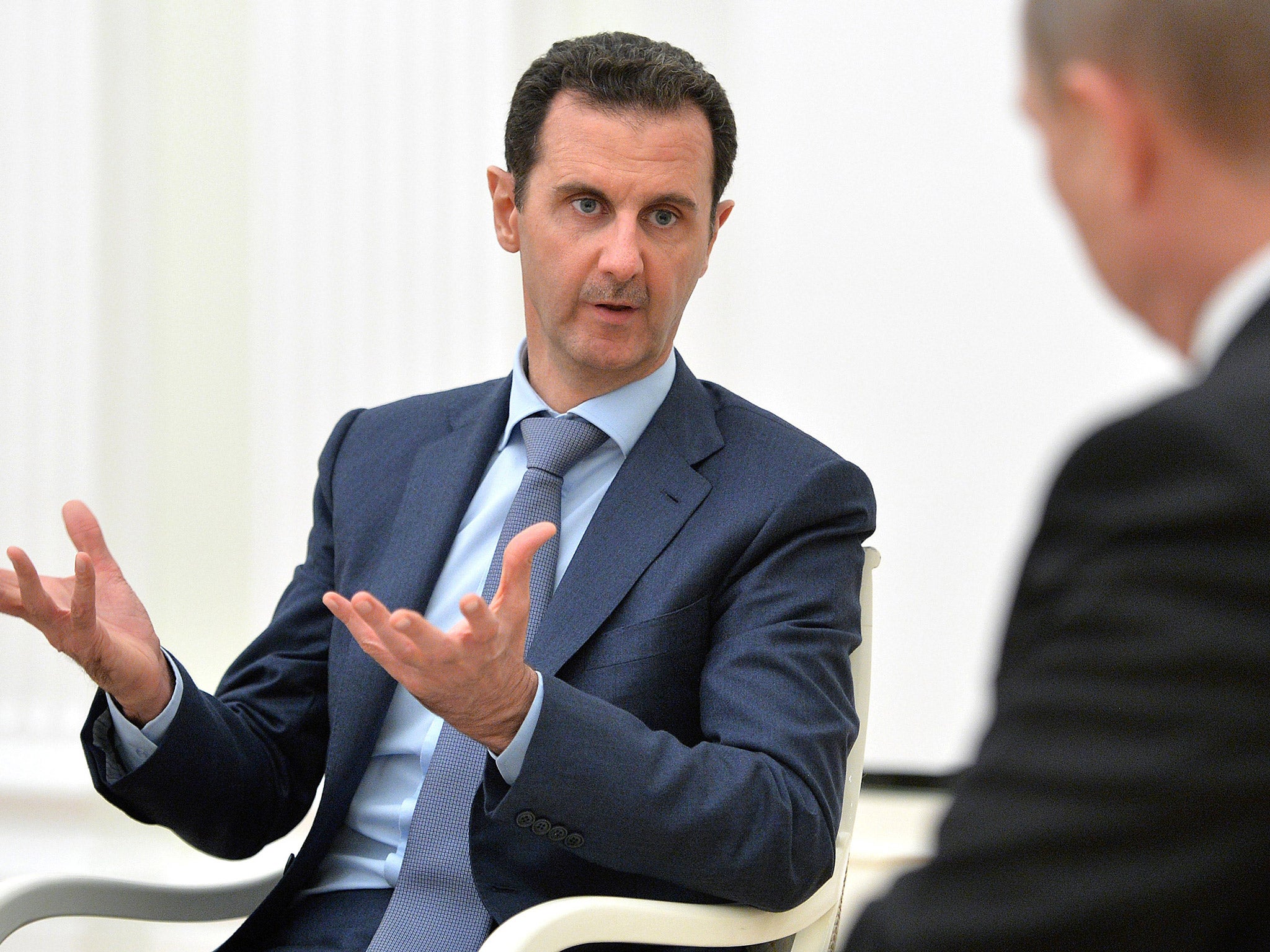 President Bashar al-Assad speaks with Vladimir Putin last month (Getty)