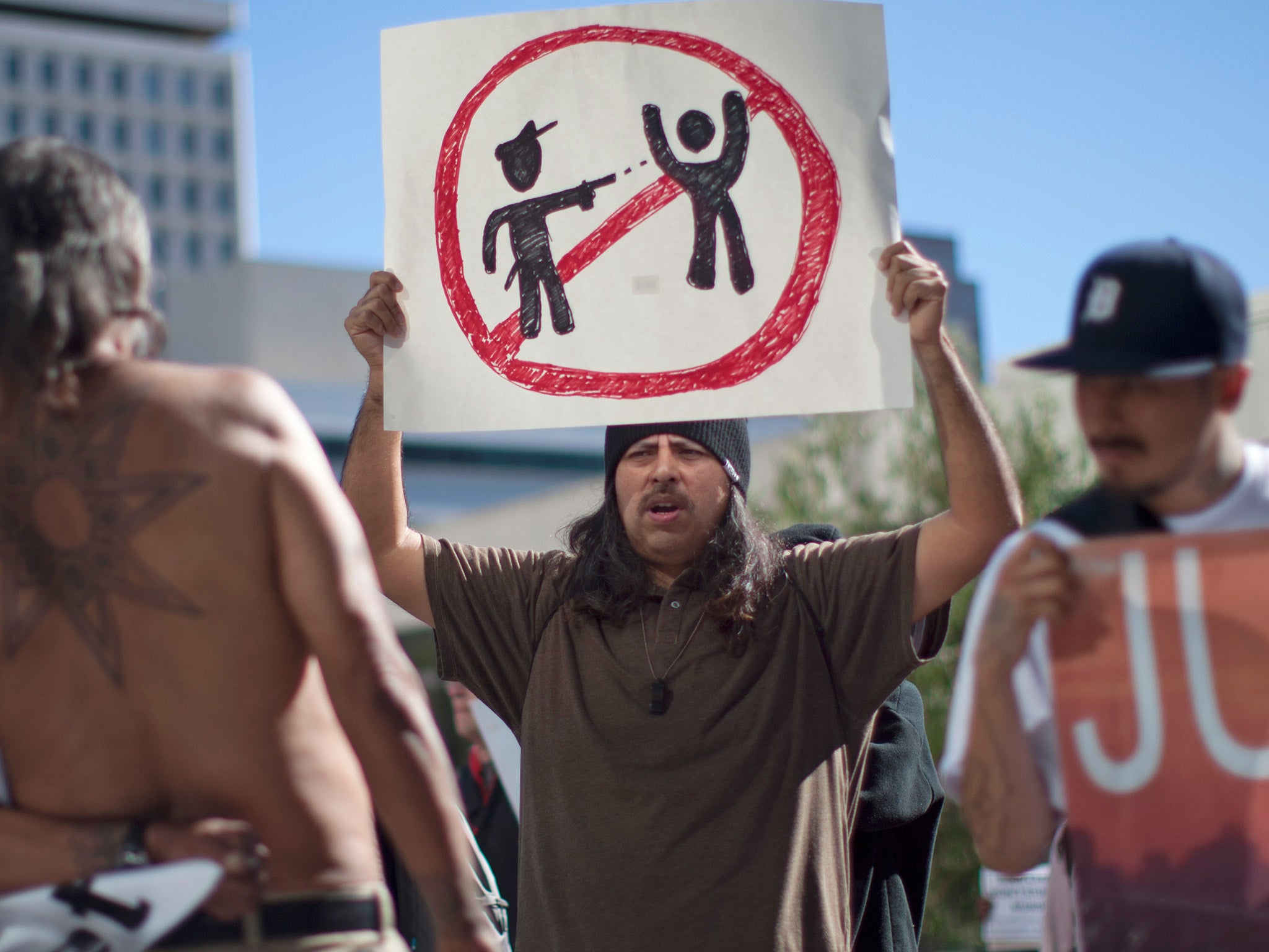 Protesters express their anger over the fatal police shooting of an unarmed homeless man, in Los Angeles earlier this year