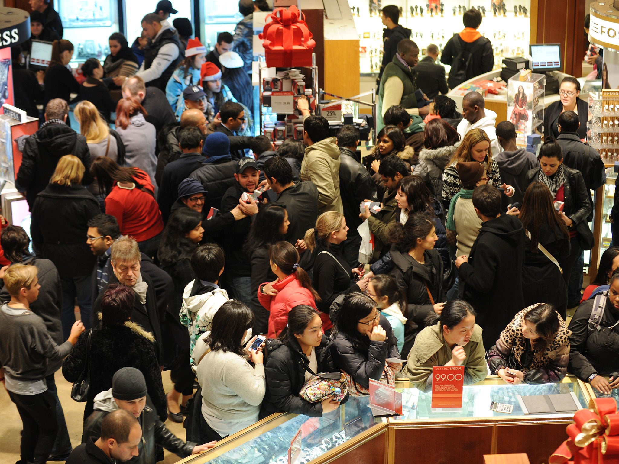 People crowd the aisles inside Macy's department store in New York after the midnight opening to begin Black Friday