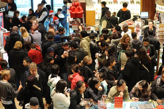 People crowd the aisles inside Macy's department store in New York after the midnight opening to begin Black Friday