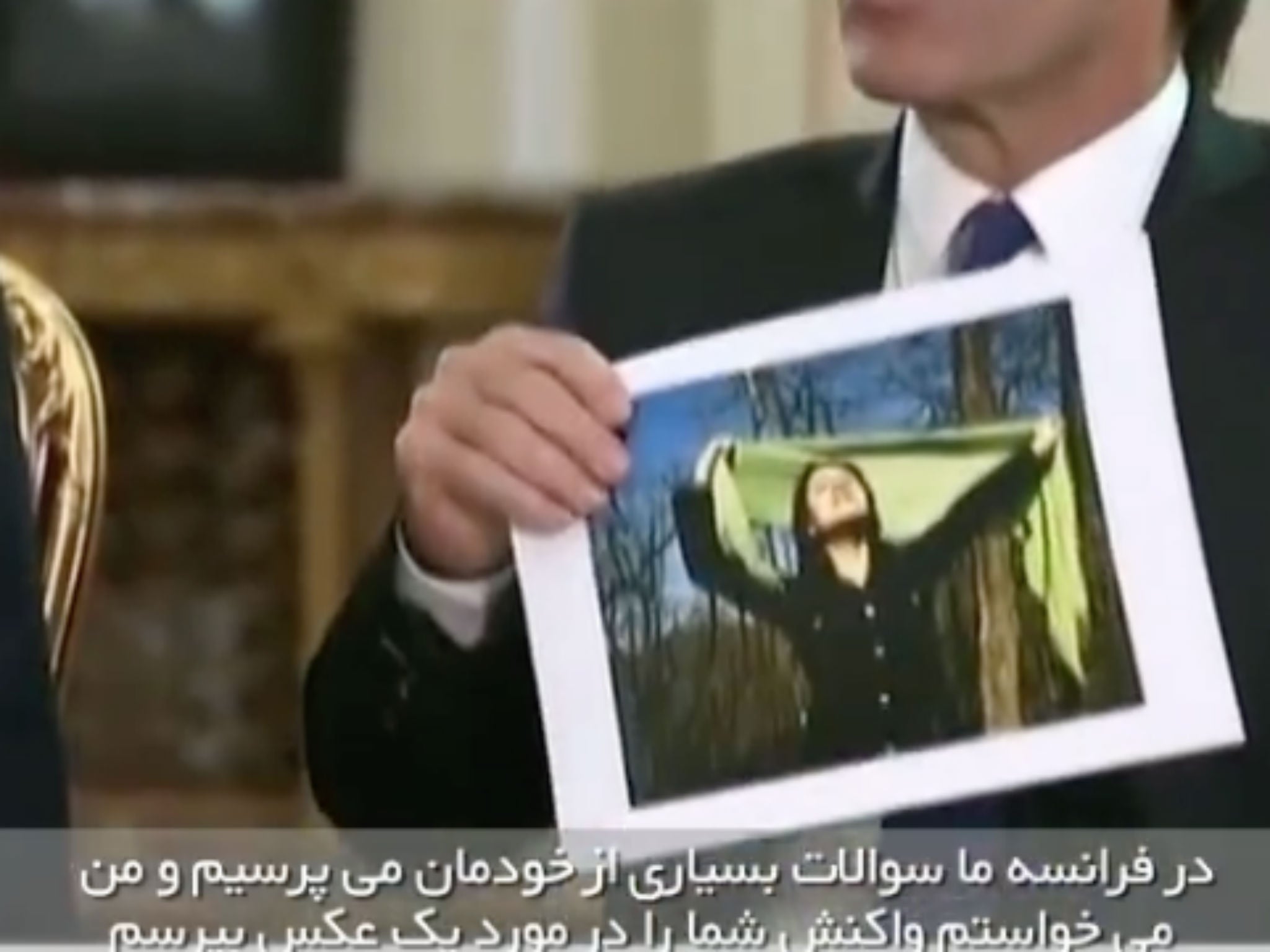 A journalist shows Rouhani the image