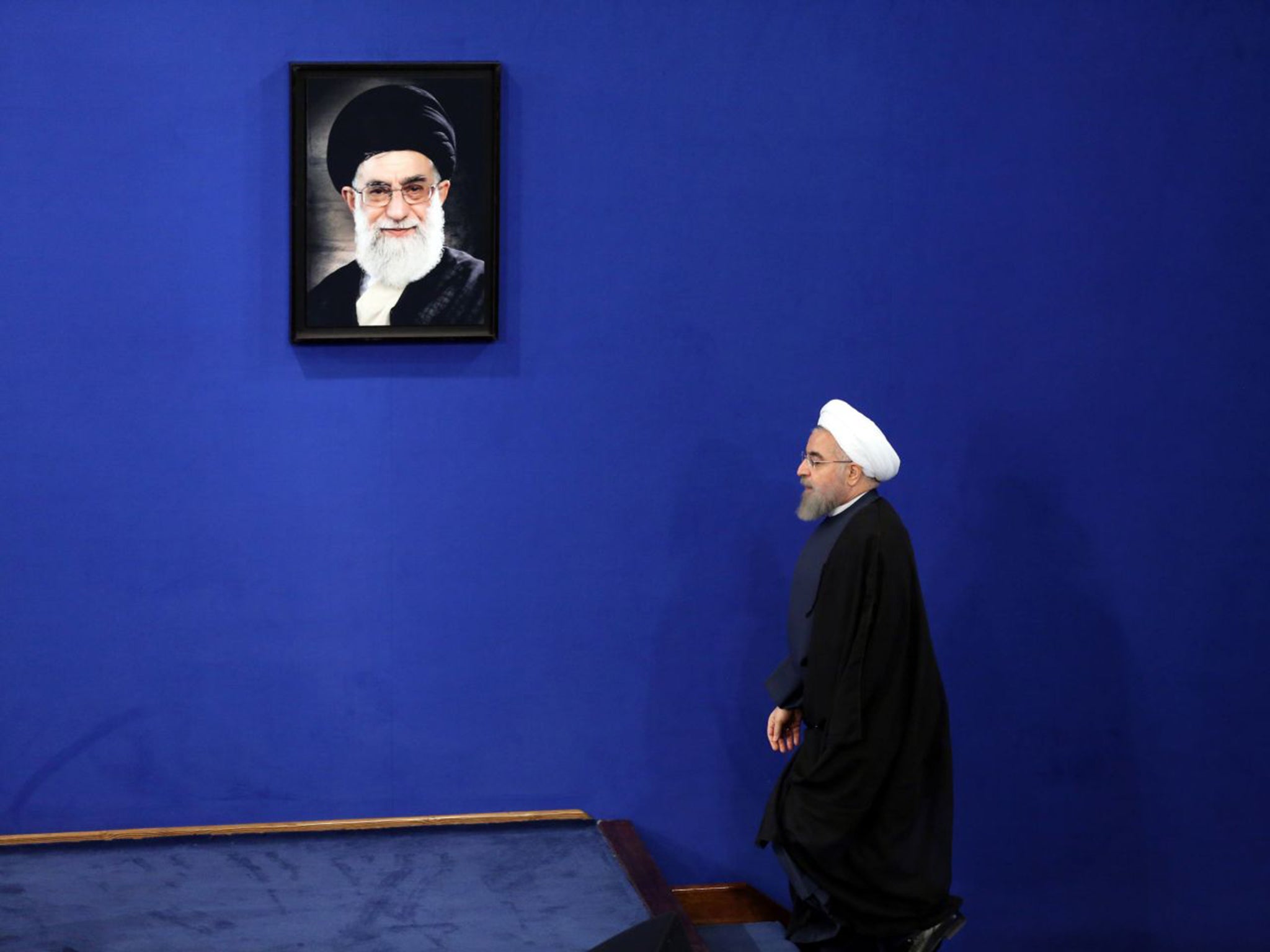 Iran’s President Hassan Rouhani, who is fighting for re-election, has indicated relations with the US could improve – but the country’s supreme leader Ayatollah Ali Khamenei (in frame) disagrees