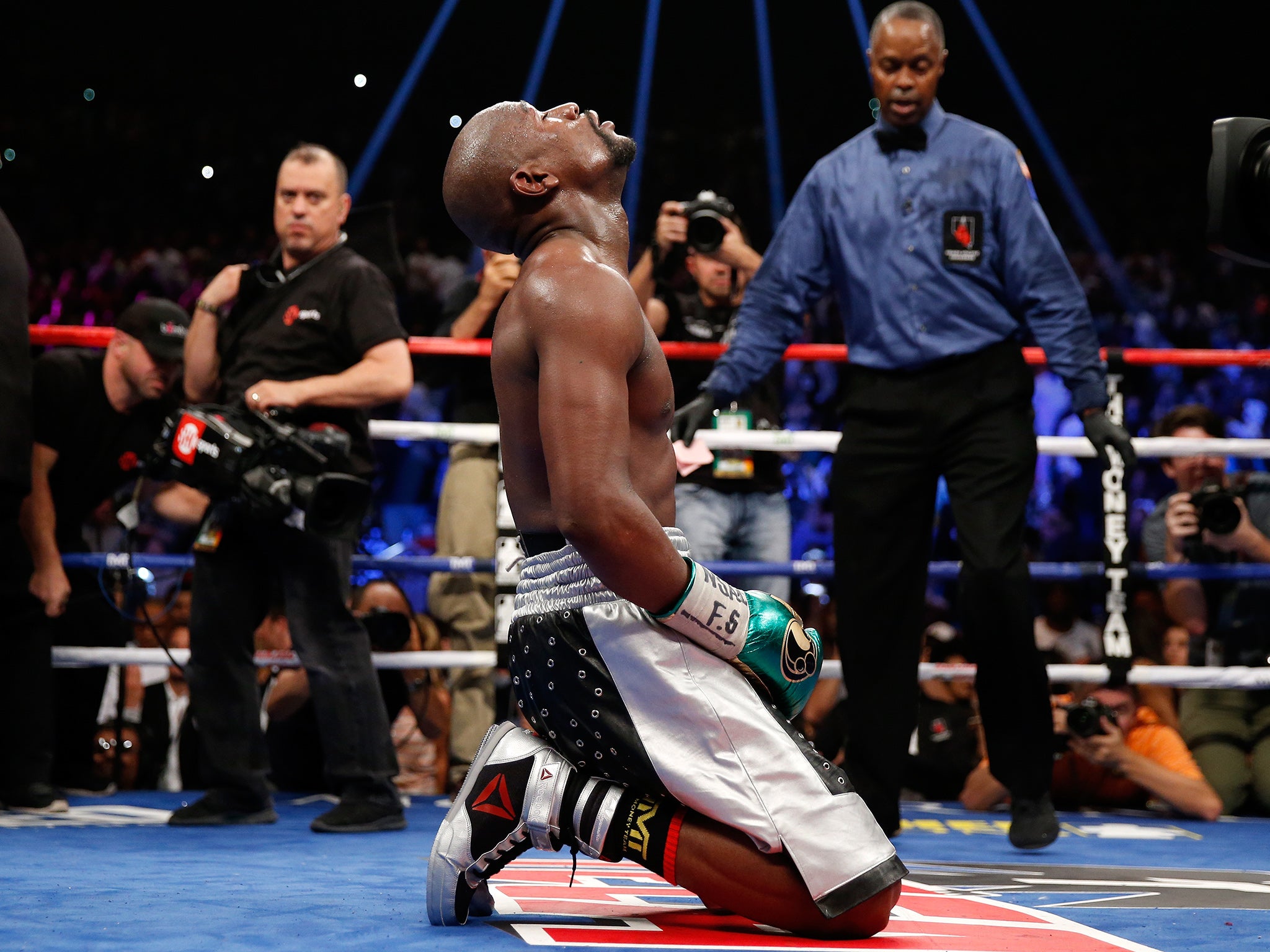 Floyd Mayweather kneeling following his victory over Andre Berto