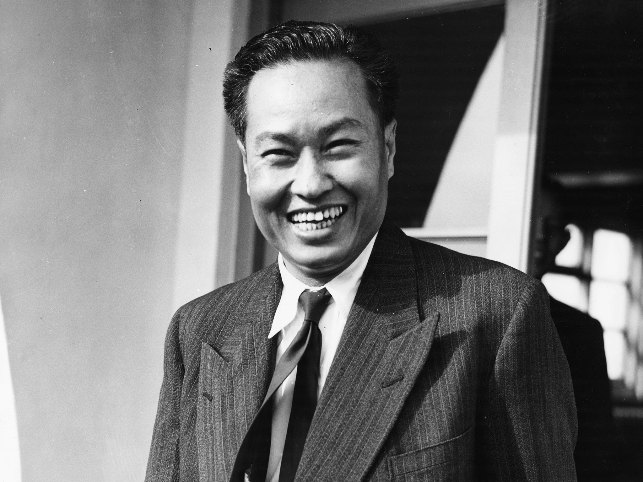 General Ne Win, smiling as he arrives in London in 1952