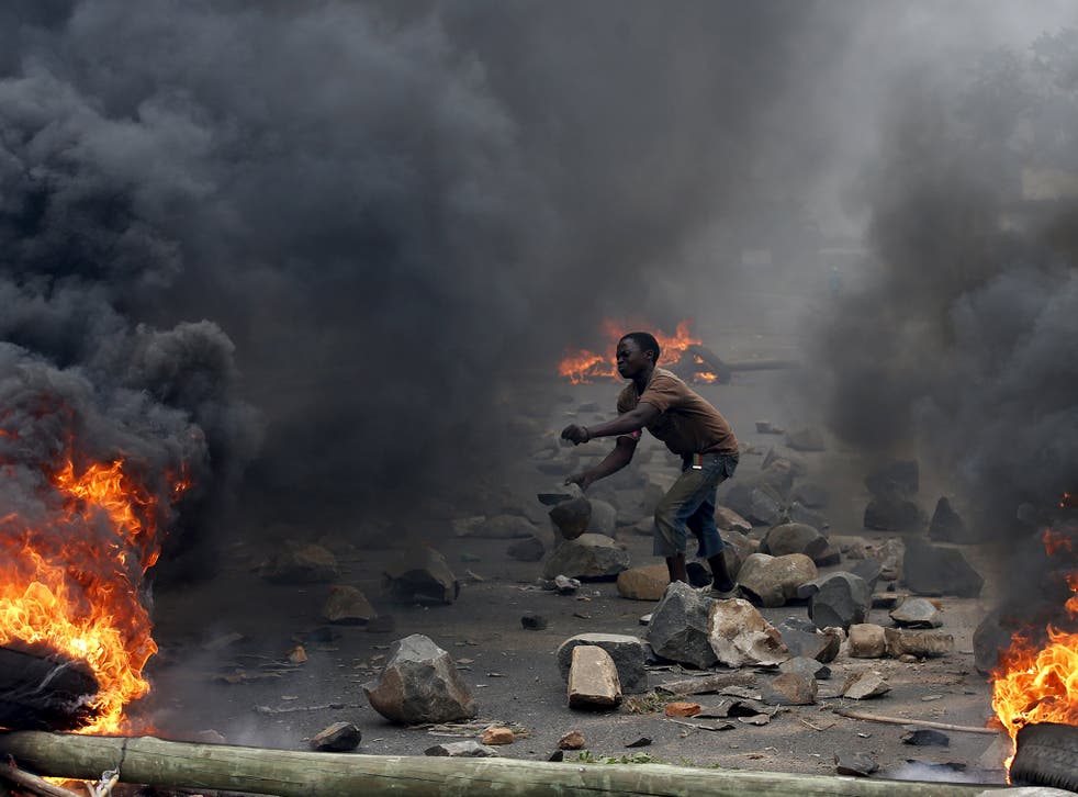 A protester sets up a  barricade during a protest against Burundi President Pierre Nkurunziza