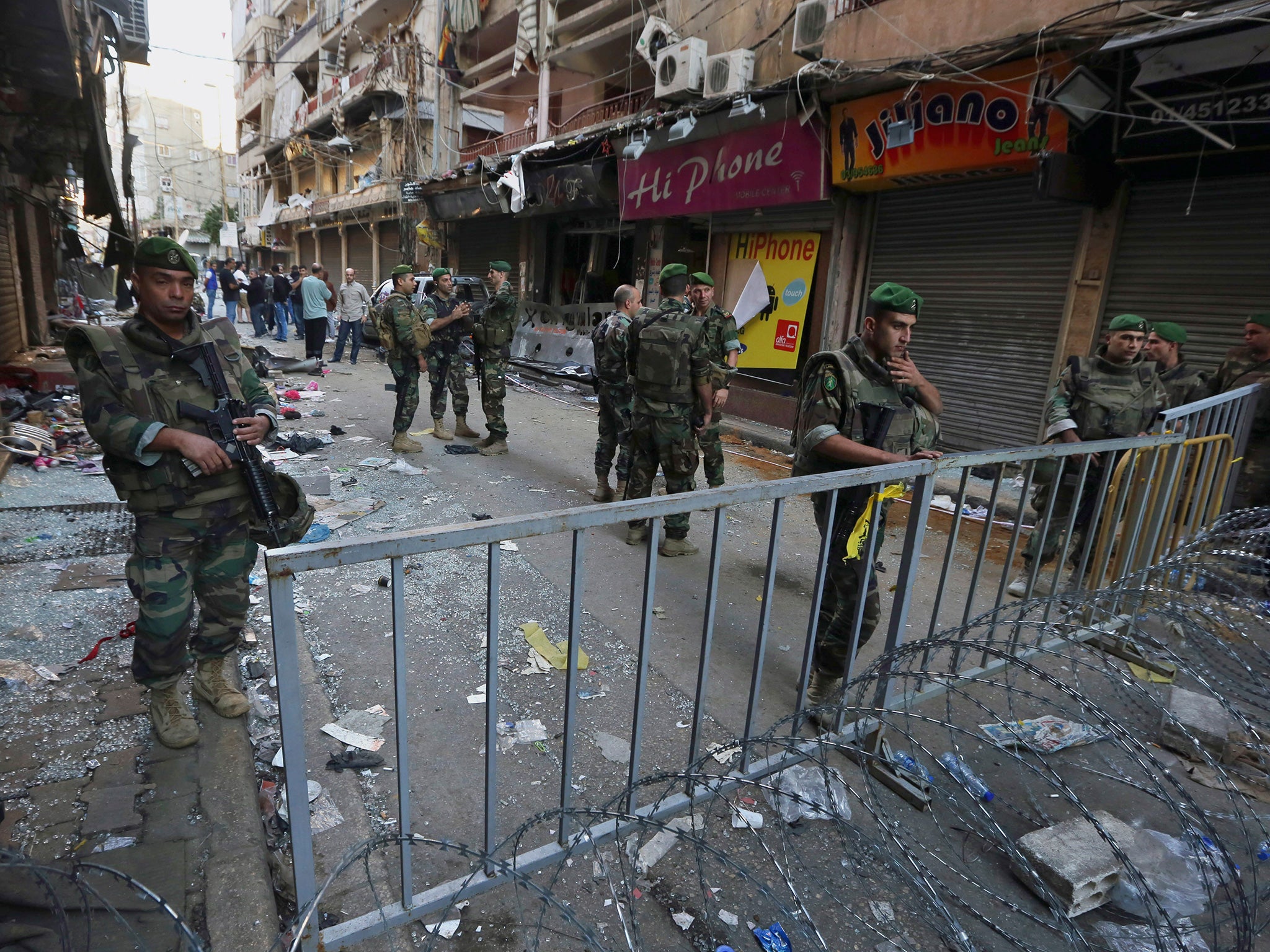 Lebanese soldiers stand guard at the scene of the attacks