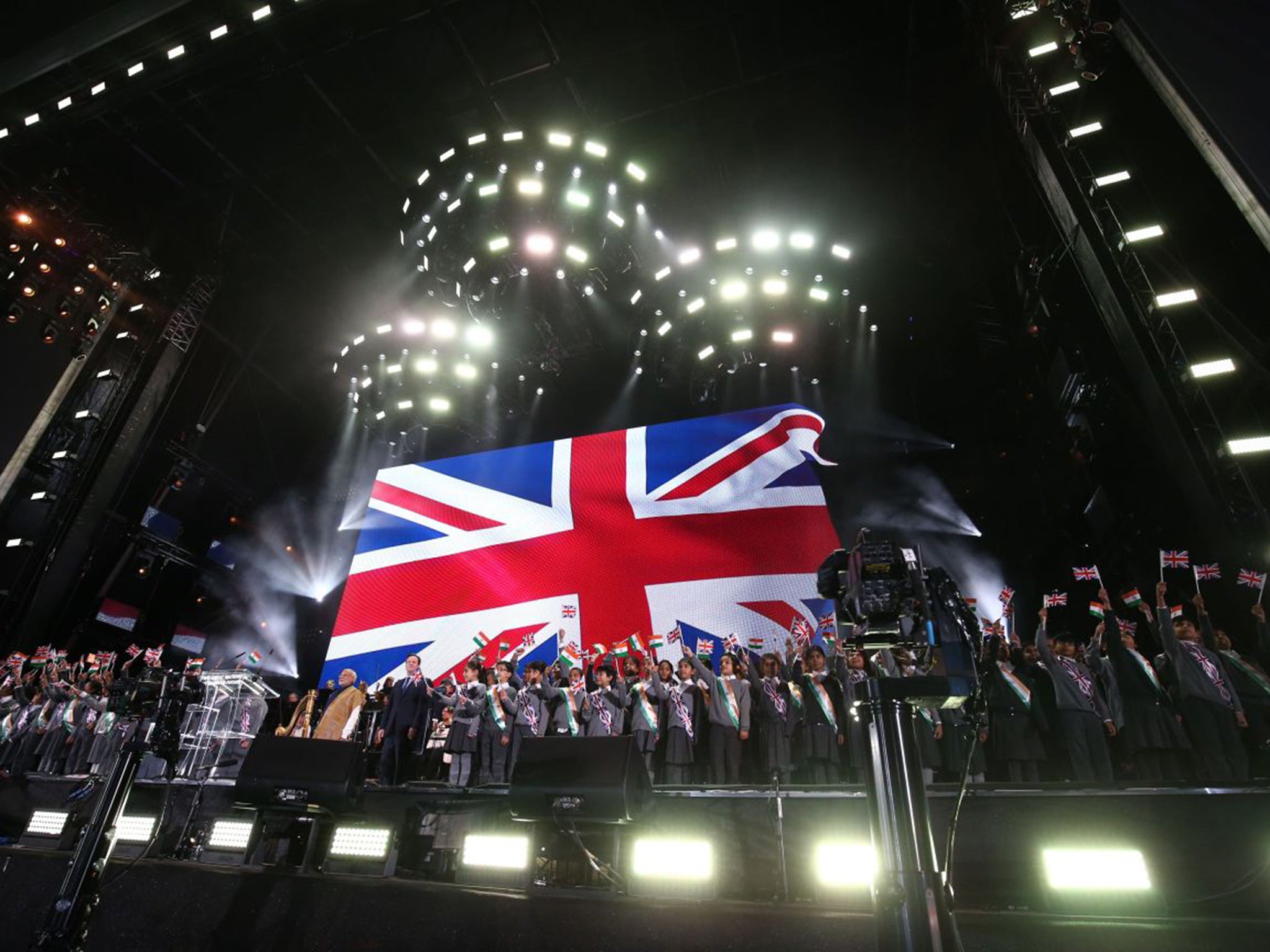 David Cameron and Narendra Modi stand on stage to sing the national anthems of both Indian and Britain at a rally to welcome the Indian prime minister