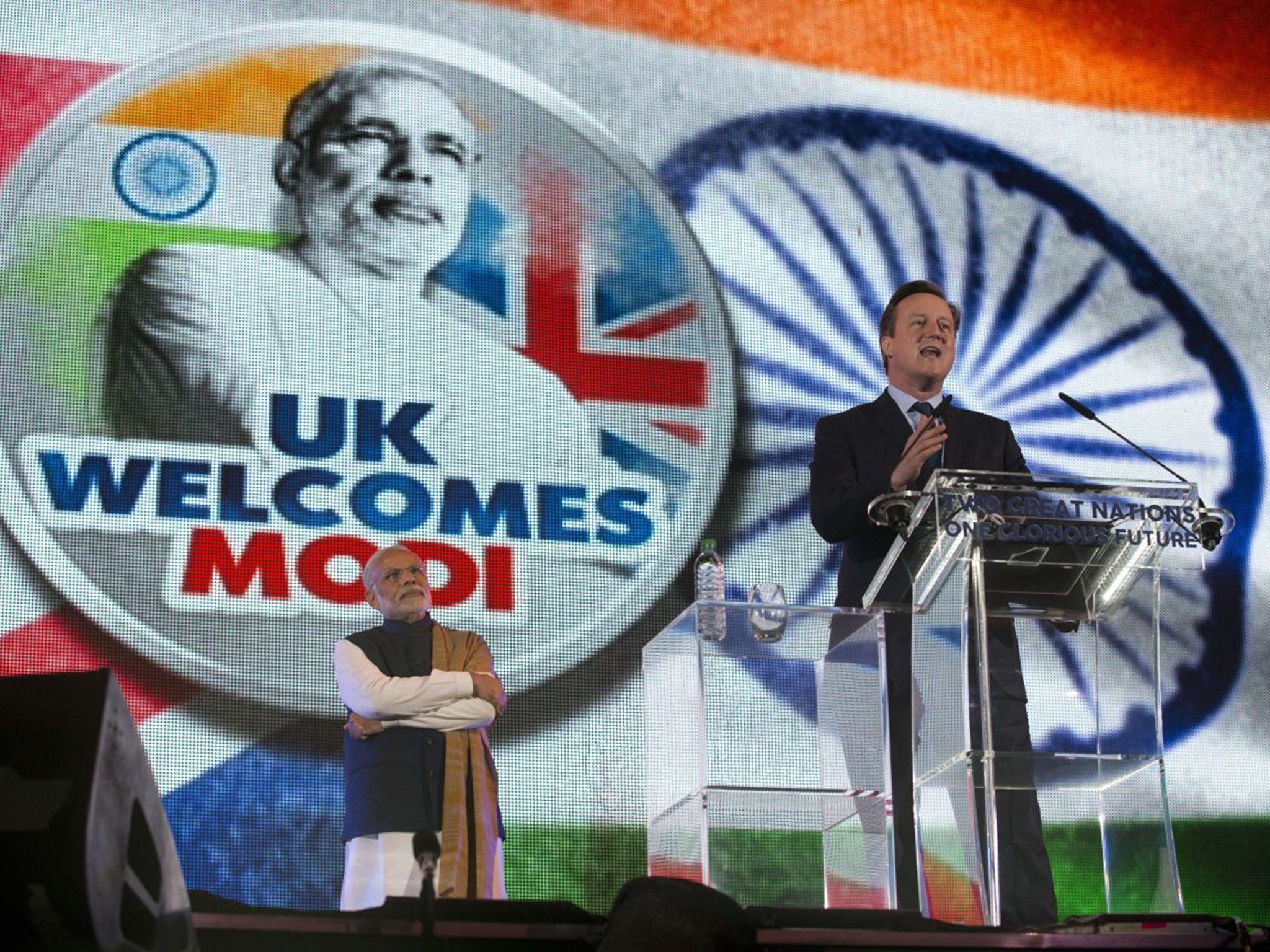 Narendra Modi stands by as David Cameron addresses the welcome rally at Wembley Stadium