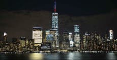 New York's One World Trade Center spire lit blue, white and red 