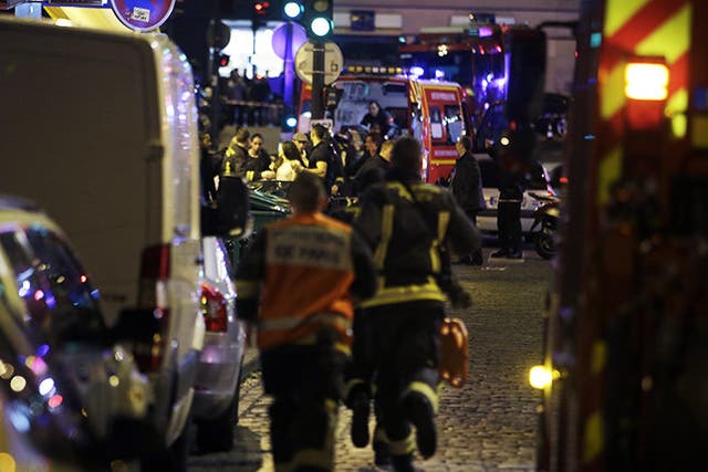 Police and rescuers work at the scene of an attack in Paris.