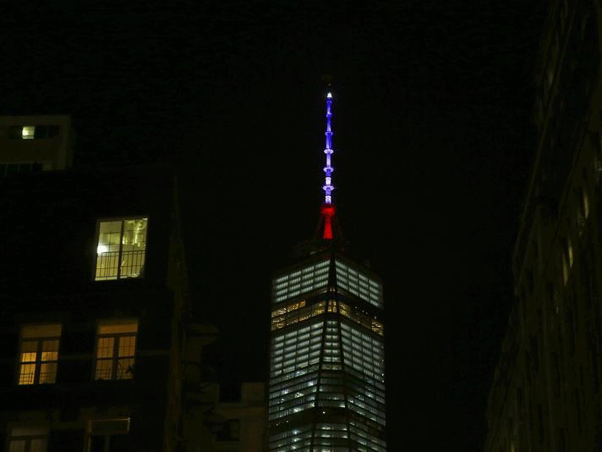 One World Trade Center is lit in the Manhattan borough of New York November 13, 2015.