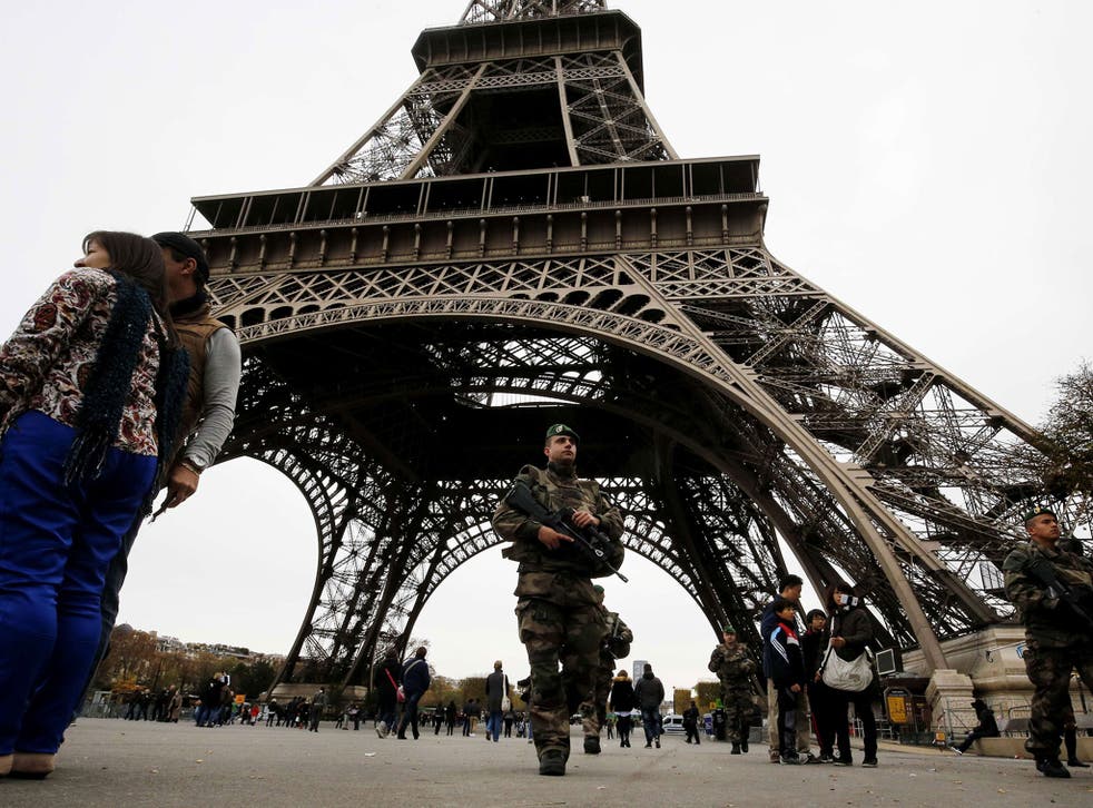 French soldiers patrol the area at the foot of the Eiffel Tower in Paris on November 14, 2015