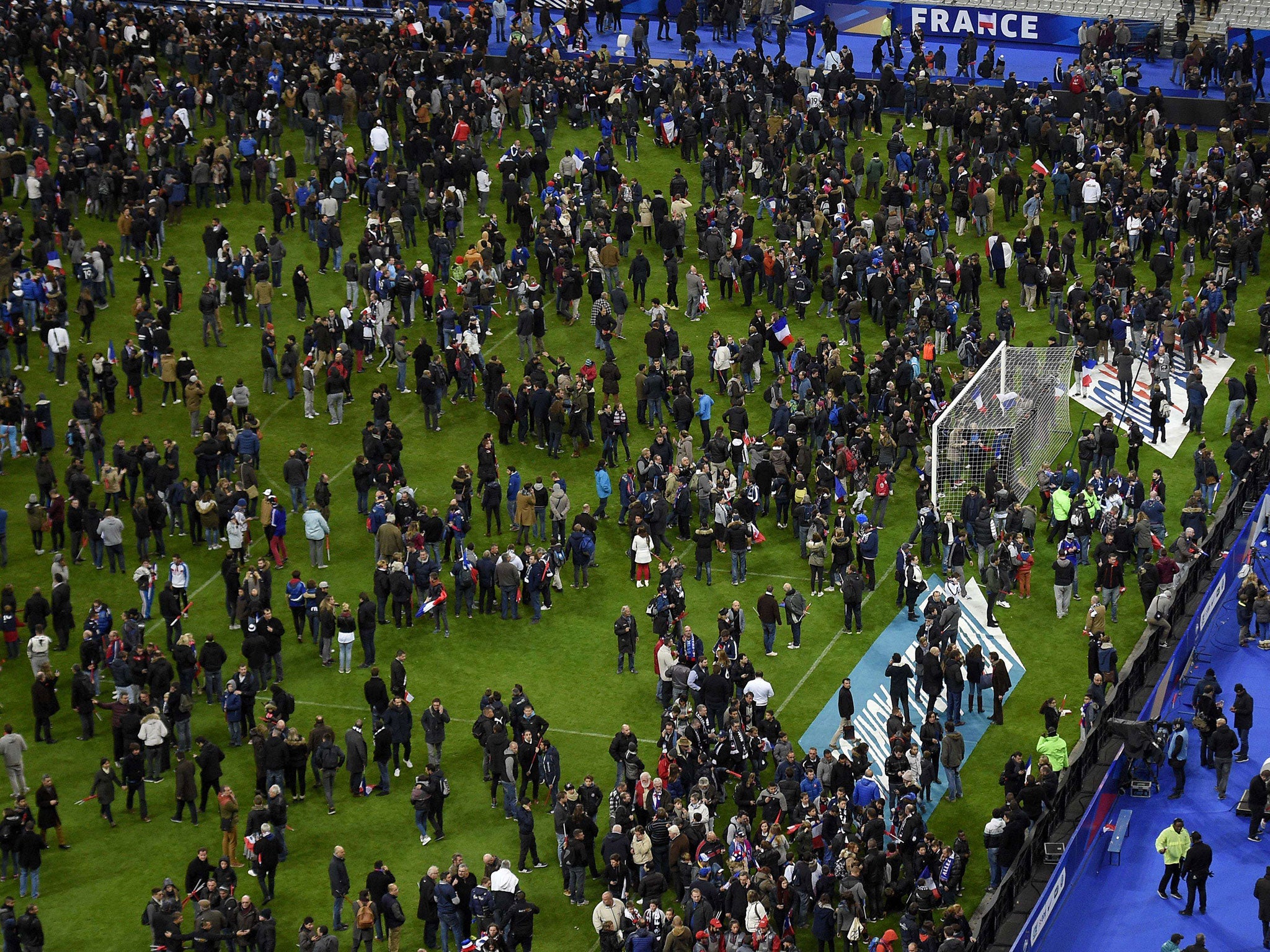 Fans at the Stade de France gather on the pitch after the Paris attacks