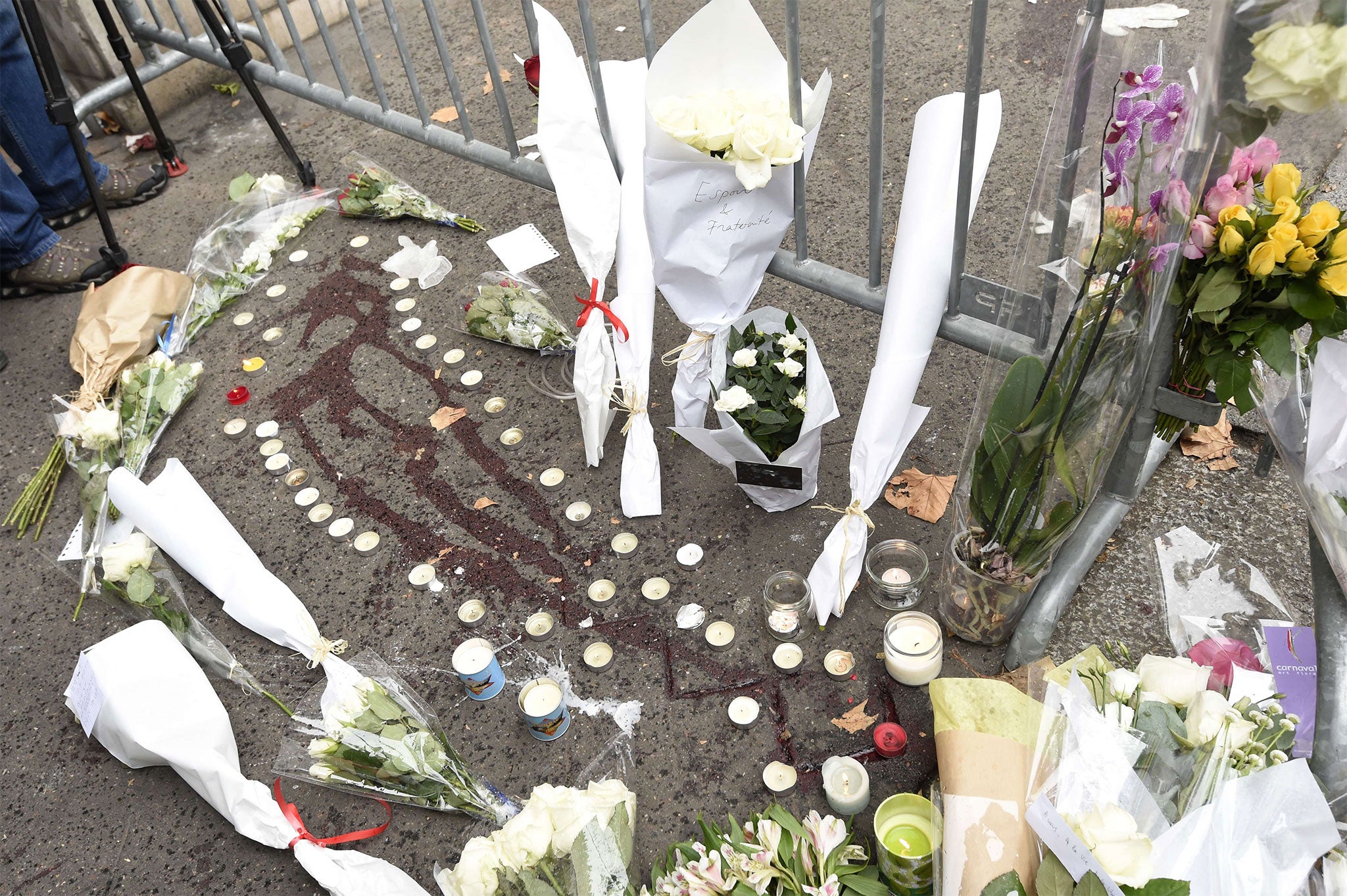 Tributes lie on top of blood outside the Bataclan theatre