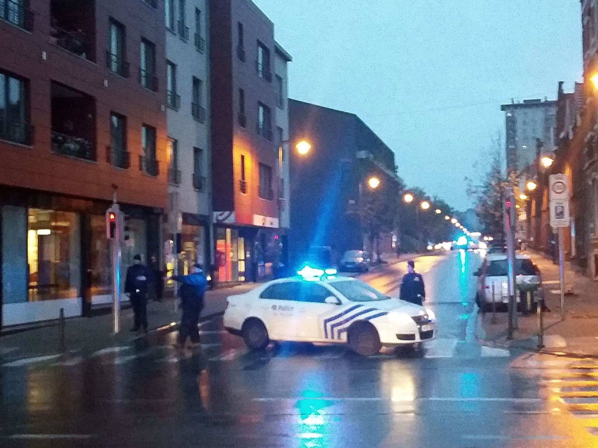 Belgian police blocking a street during a police raid in connection with the attacks in Paris, in Brussels' Molenbeek district on 14 November