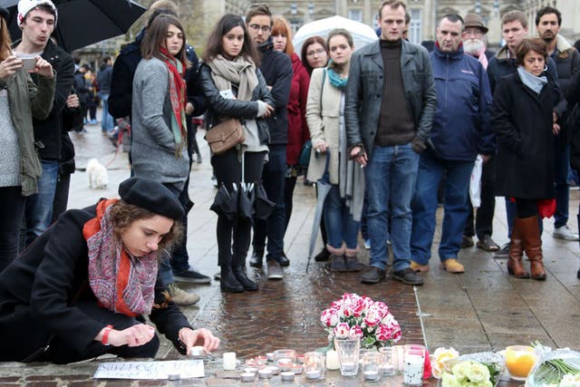 People light candles at a makeshift memorial in Lille, northern France,to pay tribute to the victims of the terror attack in Paris